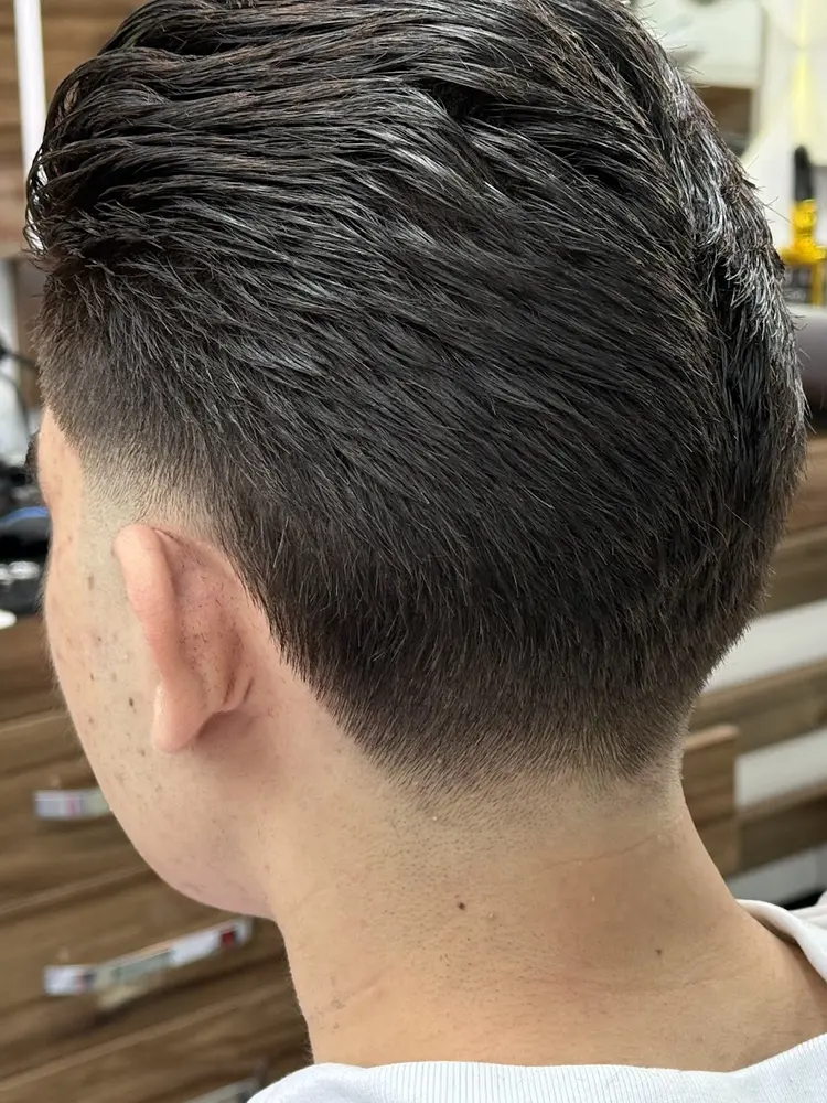 Freshly cut low taper fade, cleanly blended at the neckline